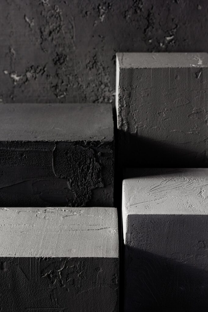 Concrete cube construction brick near wall background texture. Abstract art construction concept